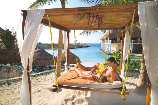Couple lying on hammock - 6 Money-Saving Tips for Planning Your Honeymoon